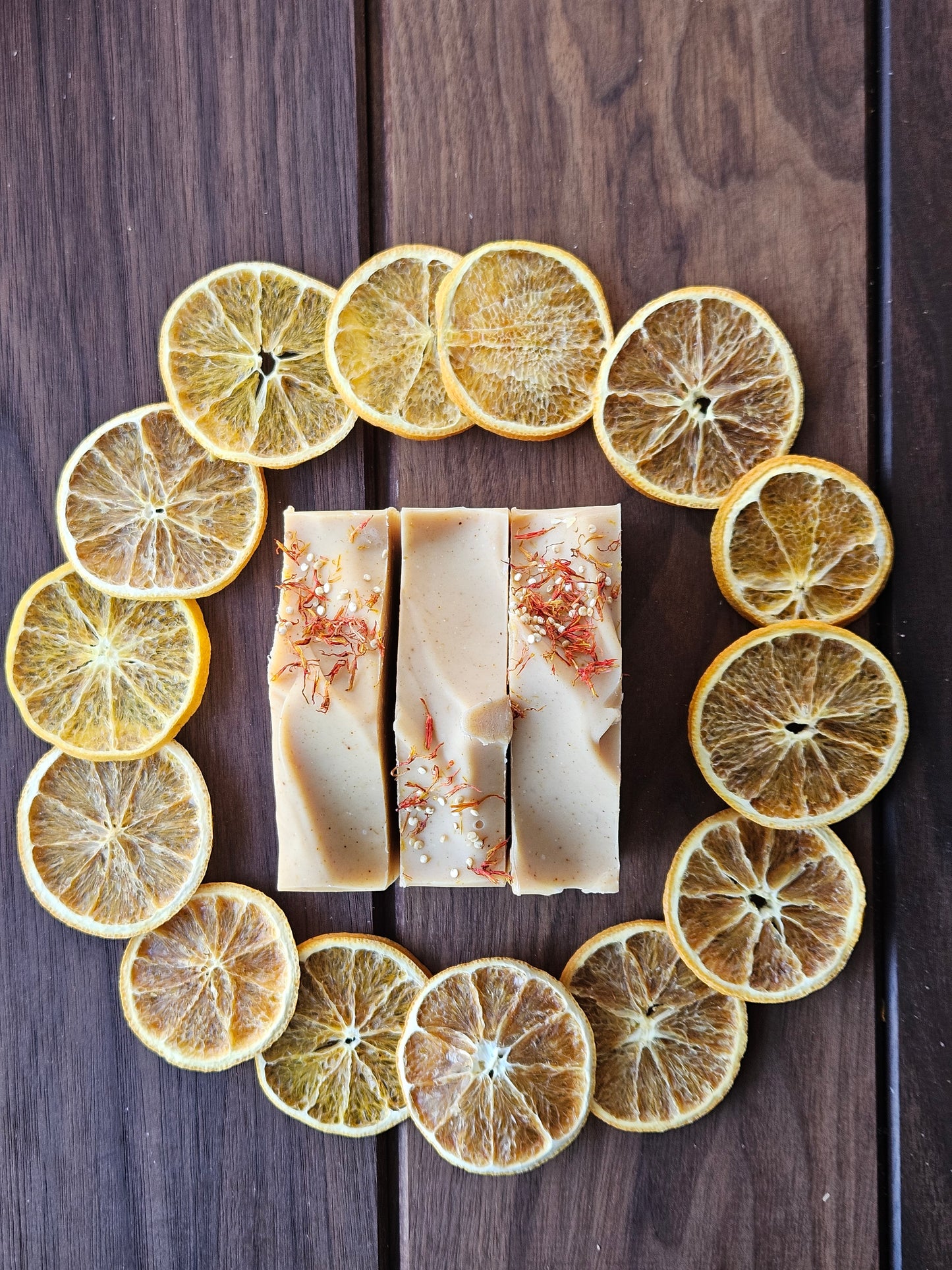 Sunlit Citrus Soap surrounded by a circle of oranges