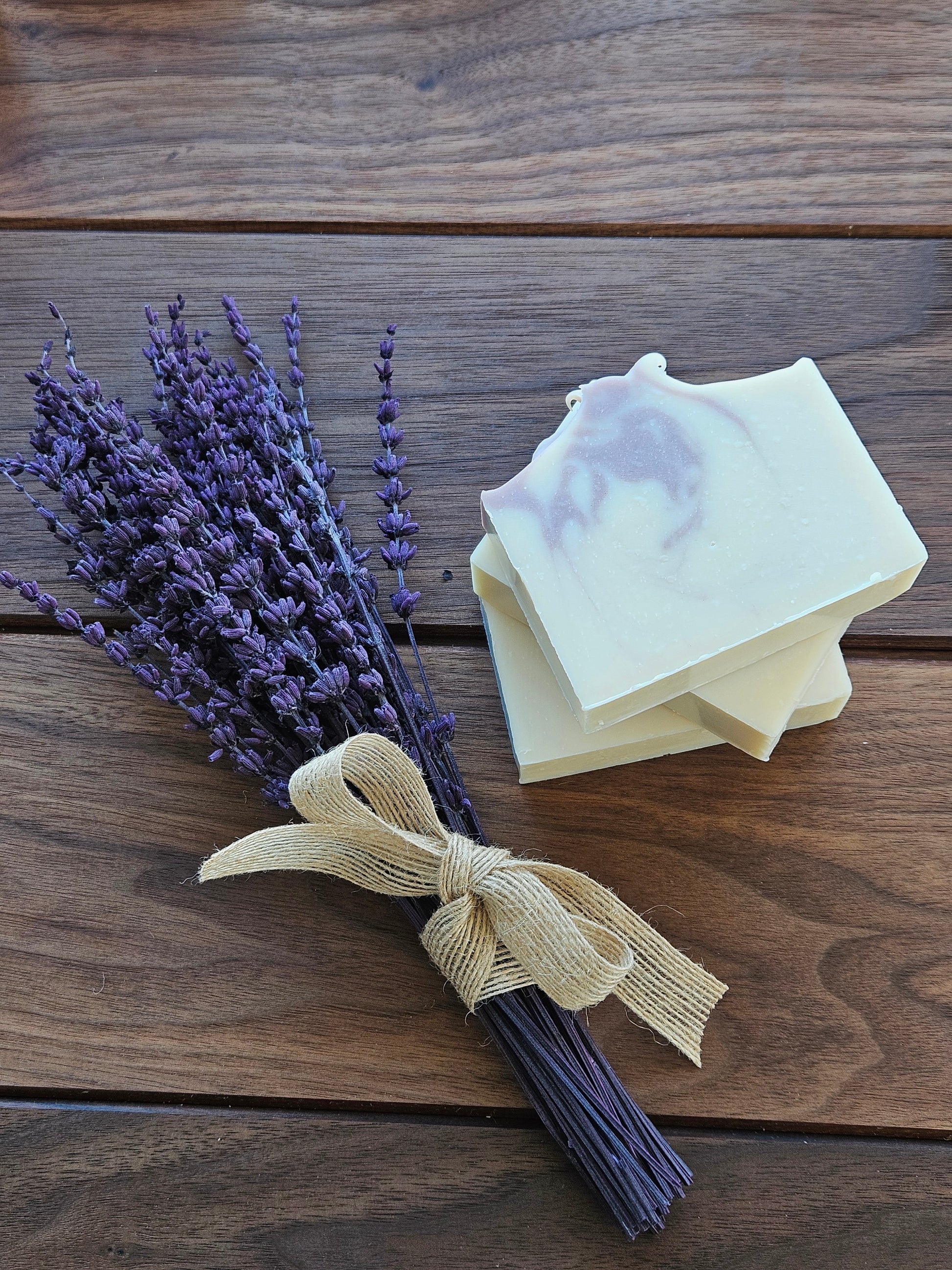 Bar of soap with lavender on a wooden surface