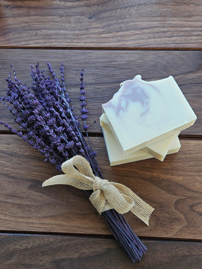 Bar of soap with lavender on a wooden surface