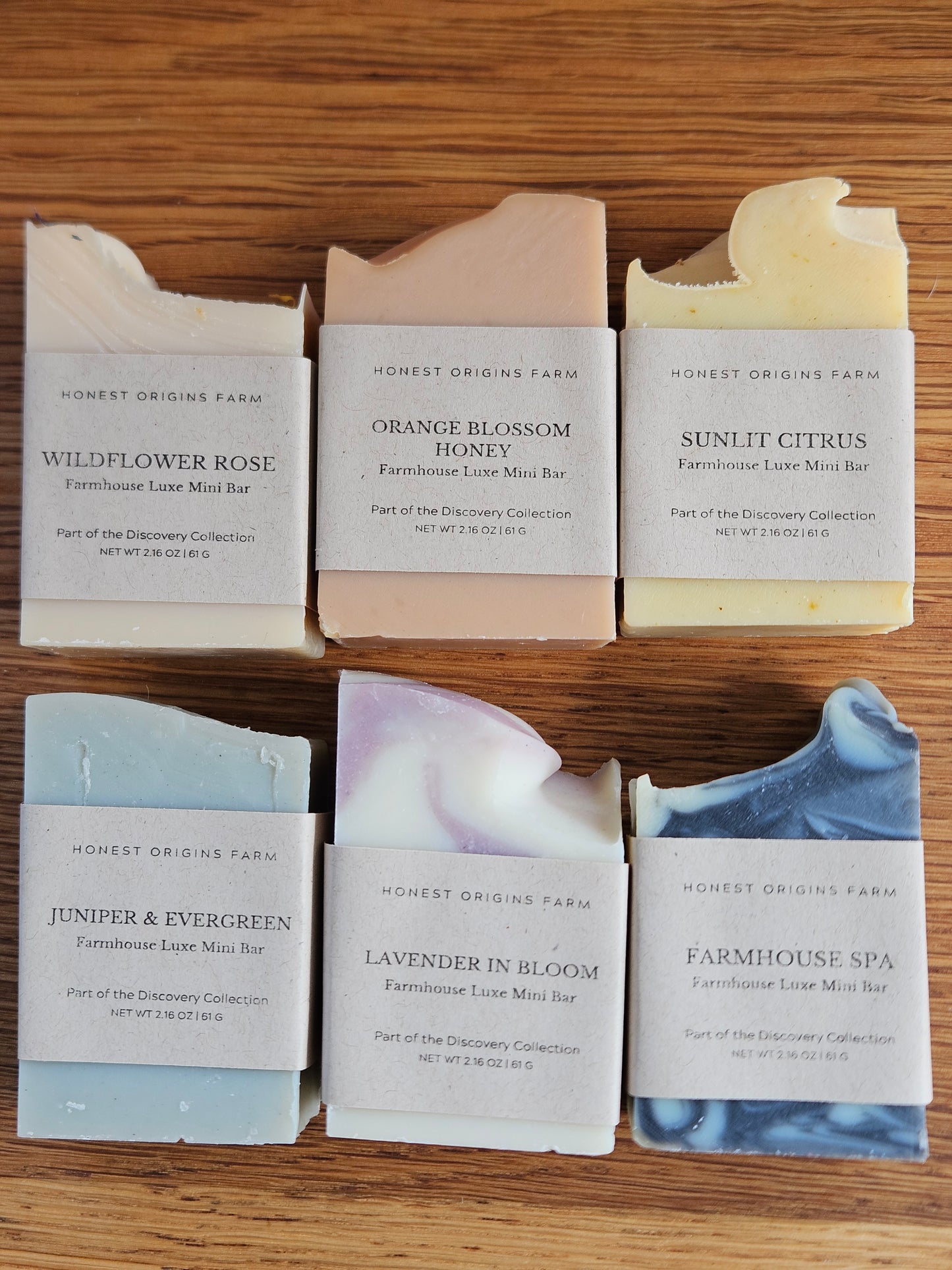 Collection of Jennifer & Evergreen soap bars on a wooden surface