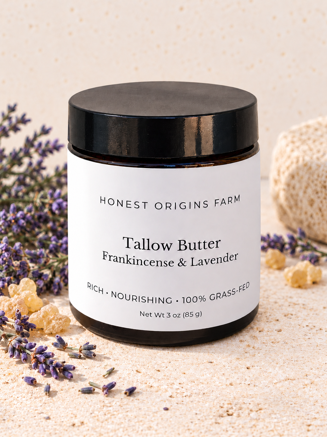 A jar of Honest Origins Farm Tallow Butter in Frankincense & Lavender scent, displayed on a textured beige surface with dried lavender and beeswax props.