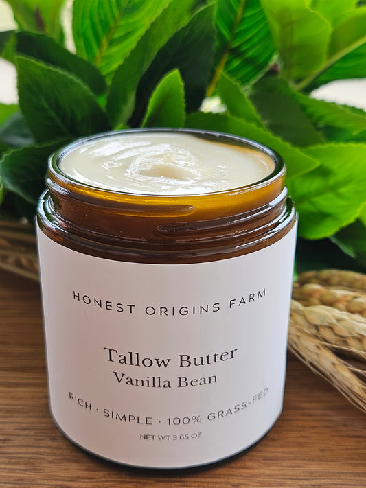 Jar of tallow butter with a plant in the background