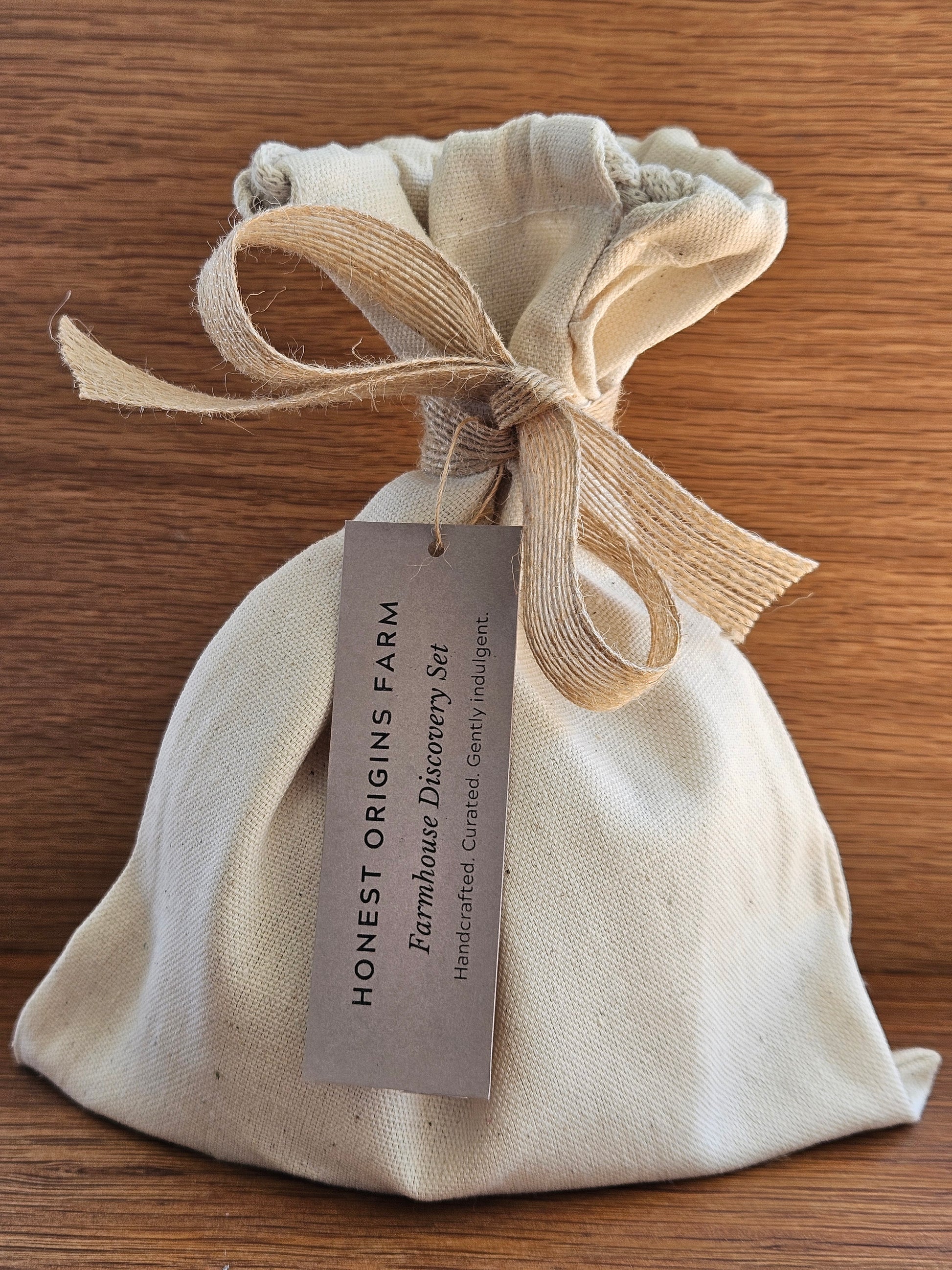 Fabric pouch with a bow and label on a wooden surface